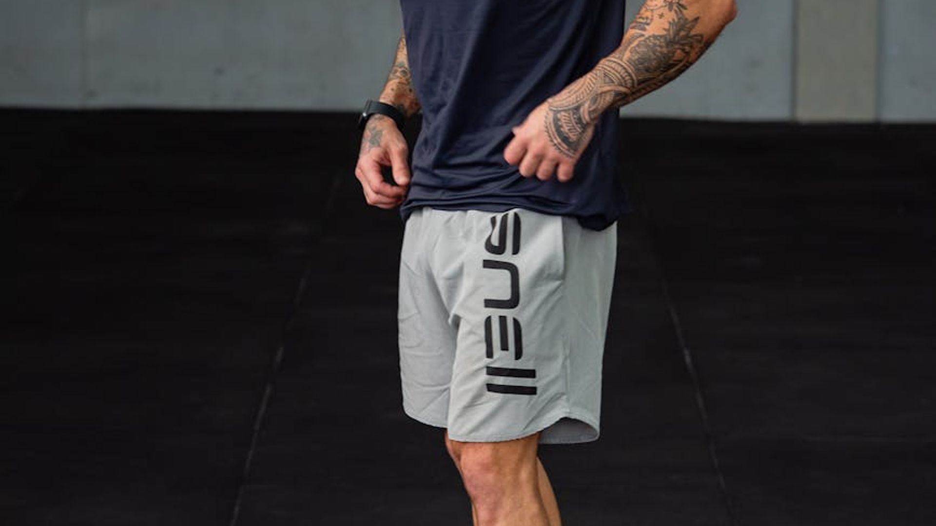Man performing focused strength exercise in modern gym environment