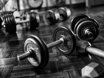 Pair of heavy black dumbbells on a grey floor